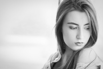 sensual sad female portrait with near window, monochrome