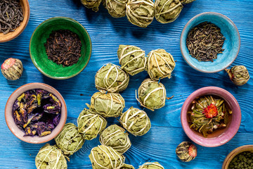 Different kinds of herbal tea on blue background top view