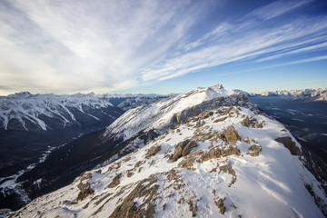 Fototapeta na wymiar View to a deep winter valley from top of the high mountain ridge, Banff national park, Canada