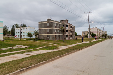 Fototapeta na wymiar GIBARA, CUBA - JAN 29, 2016: Dilipitated concrete blocks of flats in Gibara village, Cuba
