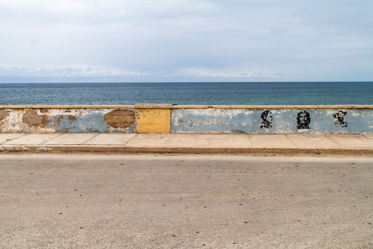 Waterfront In Gibara Village, Cuba. Portraits Of Julio Antonio Mella, Che Guevara And Camilo Cienfuegos.