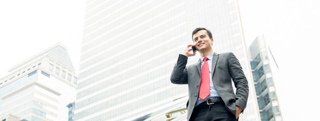 Businessman calling on mobile phone in the city