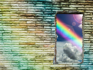 brick wall colorful hole has rainbow and sunlight