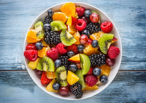 Fototapeta Fruit fresh mixed tropical fruit salad. Bowl of healthy fresh fruit salad - died and fitness concept.