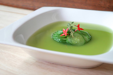 Zucchini consomme, decorate with ixora