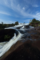 waterfall landscape  in tropical Rainforest , slow shutter speed to blur the water.Blue sky background,Thailand