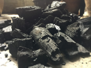 the black charcoal on cement ground floor inabstract design,light tone,blurry light around.