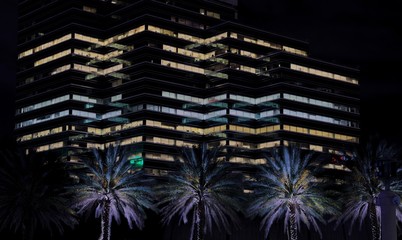 View of an office building at night creating an interesting zig zag pattern from its lights with...