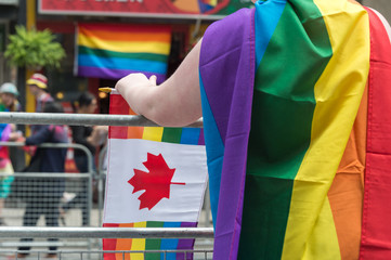 Toronto, CA - 25 June 2017: A girl with rainbow gay flag on her back at Toronto Gay Pride Parade