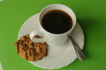 Coffee cup with sandwich cookies for business breakfast