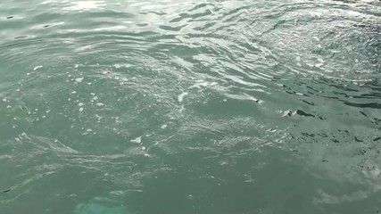 Kas, Turkey -- March 17, 2015: Filming the 1st stage of the Underwater cleaning activities at Kas harbor -- Air bubbles on the sea surface from divers working underwater