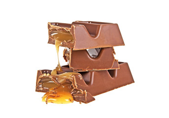 Broken chocolate bar with caramel on a white background