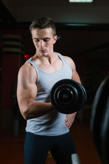 Fototapeta na wymiar Closeup portrait of a muscular man workout with barbell at gym. Deadlift barbells workout.