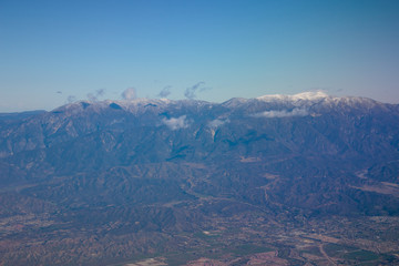 Photo of mountain range and big city seen from above