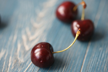 Berries of ripe cherries on a wooden background.
