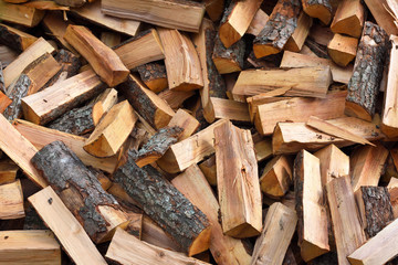 Firewood background - chopped firewood on a stack