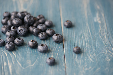 Blueberries on a turquoise wooden background