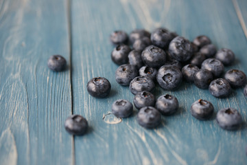 Blueberries on a turquoise wooden background