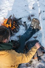Fototapeta na wymiar Camping concept. Bonfire on a winter day in a wood.
