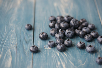 Blueberries on a turquoise wooden background