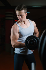 Fototapeta na wymiar Closeup portrait of a muscular man workout with barbell at gym. Deadlift barbells workout.