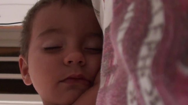 Sweet one and a half years old boy sleeps on his hand