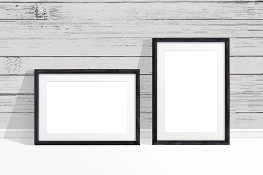 Two photo frames mock up near old painted wooden planks wall