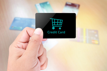 Blank card held by hand on blurred abstract background of credit card