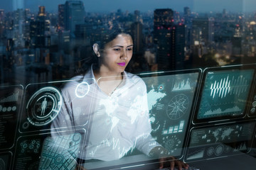 businesswoman looking at futuristic interface screen.