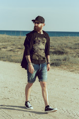 Portrait of a stylish, sexy, young man on a background of the sea