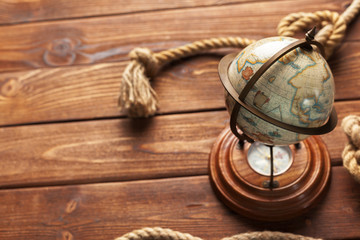 Compass and rope on wooden table. close up