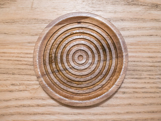 top view of wood saucer on wood table