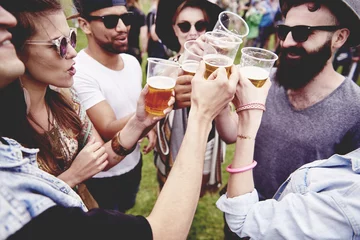 Fotobehang Group of friends drinking a beer at the festival © gpointstudio