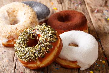 Glazed donuts with sunflower seeds and poppies close-up. horizontal