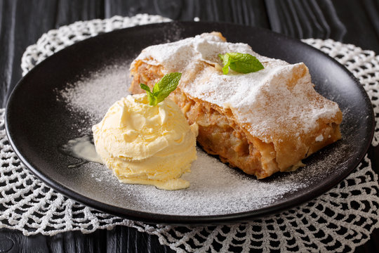 Apple strudel with vanilla ice cream close-up. Horizontal