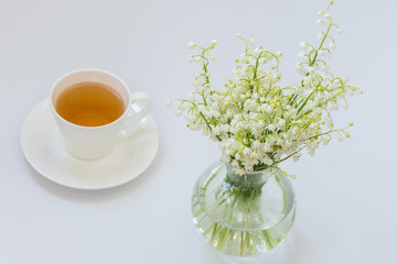 Obraz na płótnie Canvas Morning tea with lilies of the valley
