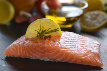 Raw salmon fillets served with lemon