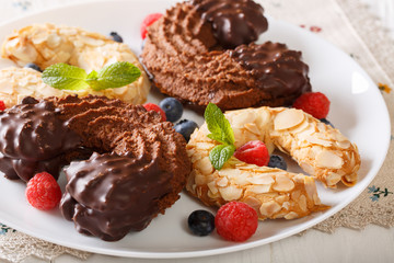 Beautiful shortbread cookie with horseshoe and chocolate and almonds close-up. horizontal