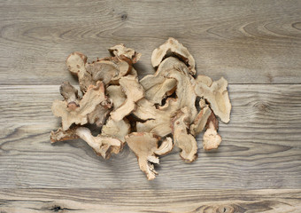 dry galangal ginger on wood background