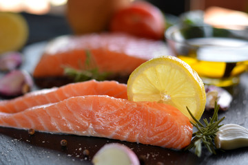 Raw salmon fillets served with lemon