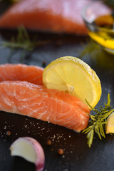 Raw salmon fillets served with lemon