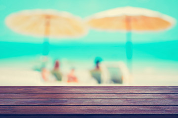 Wood table top on blurred beach background,vintage tone, summer holiday background concept