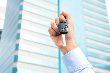 Hand holding car key