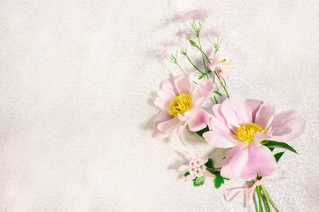 Naklejka na ściany i meble Delicate background of tree-like peony and wild flowers bouquet, top view on a gold cloth background with copy space for your text.