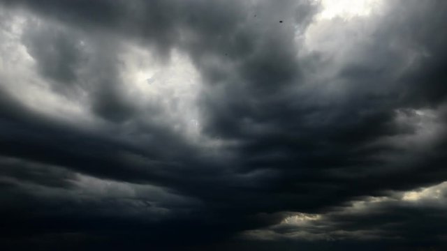 dark storm clouds are moving fast at viewer - timelapse