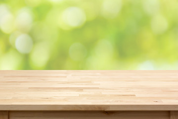 Wood table top on bokeh abstract green background