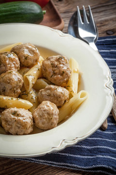 Pork meatballs with dill sauce and pasta. Selective focus.