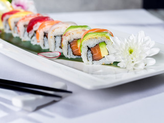 Close up of a rainbow sushi roll with salmon and avocado