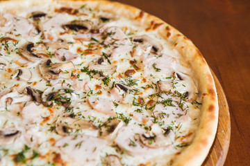 elicious pizza with meat, cheese and mushrooms