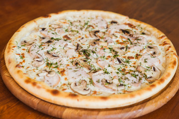 elicious pizza with meat, cheese and mushrooms